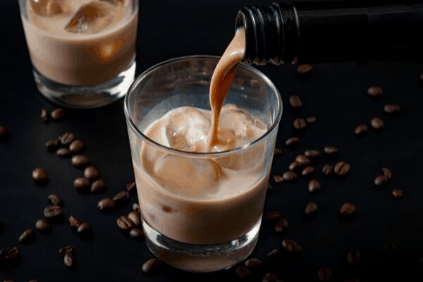 fruit liqueurs - a cream liqueur pouring over ice
