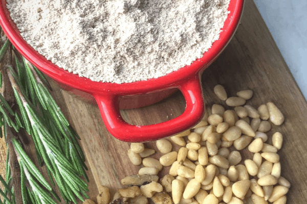 Castagnaccio - example of some ingredients including chestnut flour, rosemary and pine nuts
