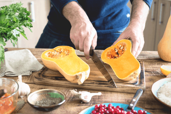 roasted harvest fall soup - butternut squash being chopped on a chopping board
