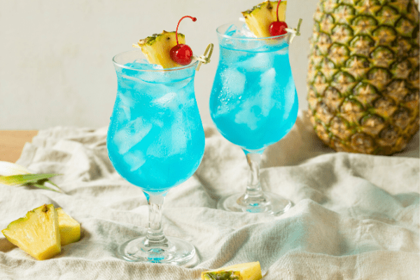 Blue Hawaiian cocktail with pineapple slice and cherry