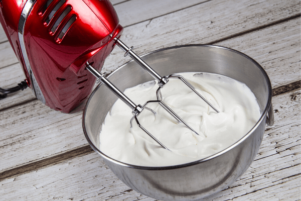 a hand mixer whipping cream