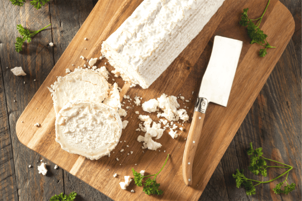 log goats cheese on chopping board